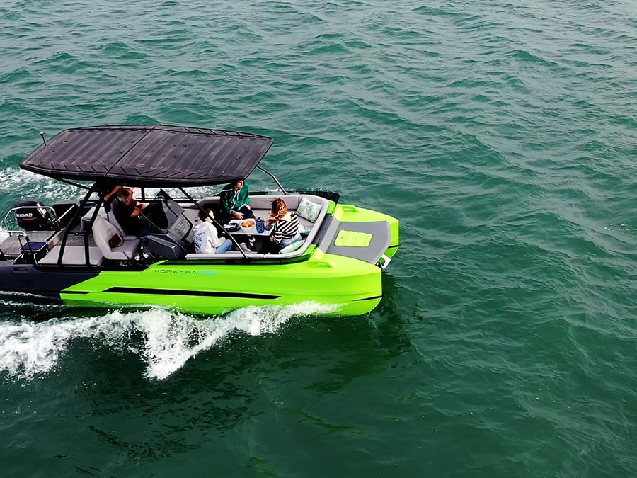 Korkyra 650 under way with the table set and six people aboard